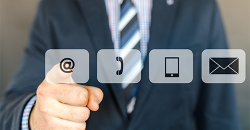 A man in a suit and tie pointing to three different icons.