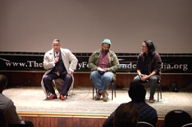 Panel discussion on stage with three speakers Black Ops Private Investigators