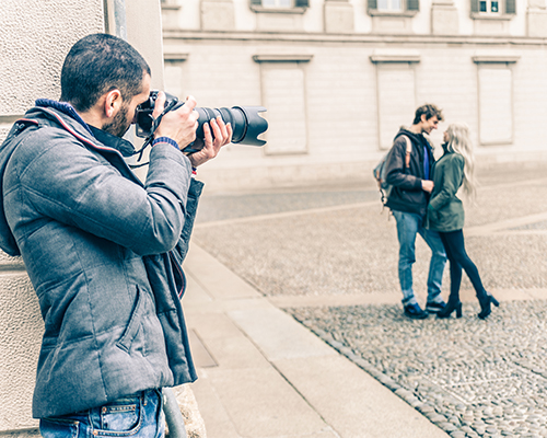 A man taking a picture of two women.