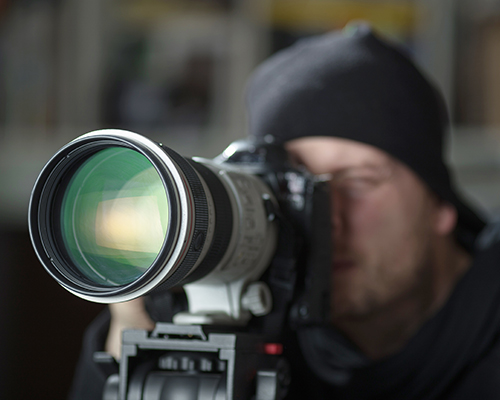 A man is taking a picture with his camera.