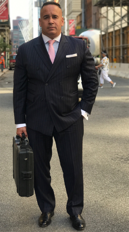 A man in a suit and tie holding a briefcase.