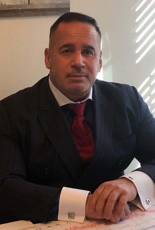 Private investigator Manuel Gomez in a suit