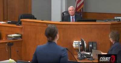 A judge and a woman in a front of the jury. A judge and a woman in a front of the jury.